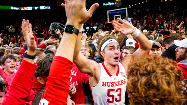 Nebraska forward Josiah Allick celebrates with fans who stormed the court after the Huskers' 88-72 win Tuesday night over top-ranked Purdue at Pinnacle Bank Arena in Lincoln.  (Jan 9, 2024)